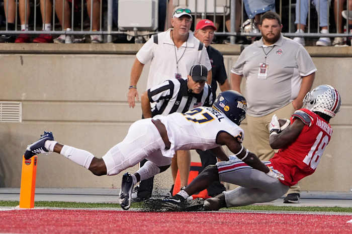 Sep 17, 2022; Columbus, Ohio, USA; Ohio State Buckeyes wide receiver Marvin Harrison Jr. (18) is hit by Toledo Rockets cornerback Quinyon Mitchell (27) as he catches a touchdown pass during the first half of the NCAA Division I football game at Ohio Stadium.